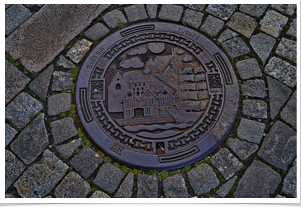 Sewer covers are old.  You can read Bergen on the left and right sides.